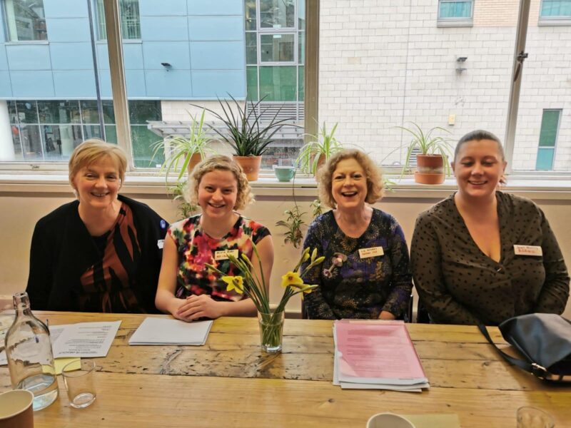 Speakers Linda, Olivia, Liz (chair) and Sarah sat at the front of the meeting