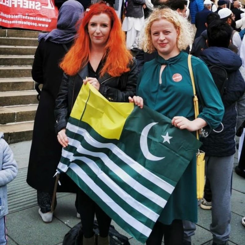 Olivia Blake MP and Louise Haigh MP with the flag of Azad Kashmir.